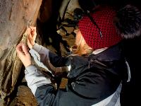 Natália Megisova from the CRL laboratory taking a sample from a drawing in the Katerinska Cave