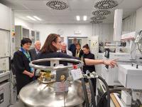 E. Zažímalová (on the left) with other guests and NPI staff watches V. Brychová's presentation in the AMS laboratory